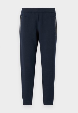 Pantaloni jogger blu navy realizzati in morbido tessuto, con gambe affusolate, tasche laterali con zip e una comoda vita elastica.