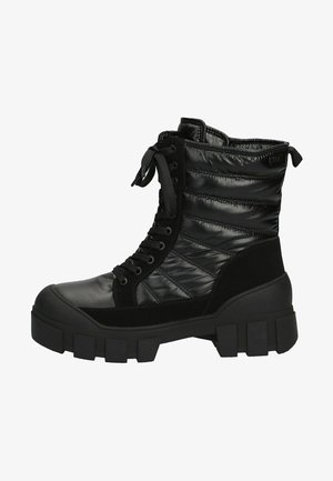 Black ankle boots with a quilted, shiny upper, suede accents, and a thick rubber sole featuring a chunky tread pattern. Lace-up design.