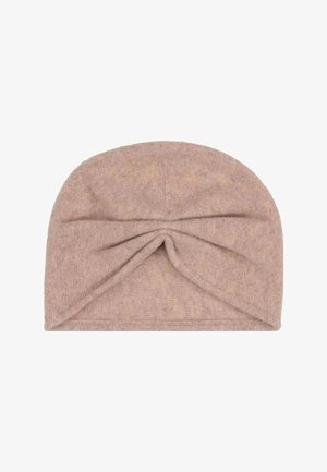 Měkký béžový turbanový headband z froté tkaniny se zkrouceným uzlem vpředu.