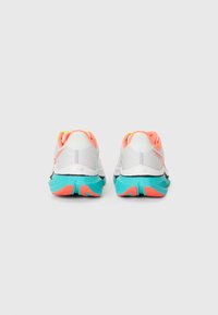 Pair of white athletic shoes with teal soles and coral accents, viewed from the back on a plain white background.
