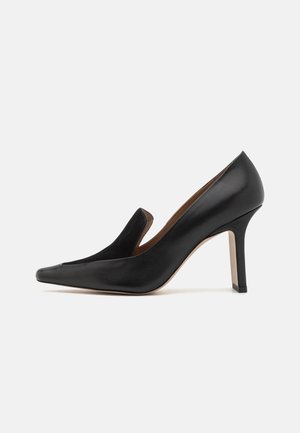 Black leather high-heeled shoe with pointed toe, curved sides, and a sleek design. Features a smooth finish and a thin stiletto heel.