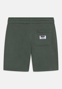 Tmavě zelené bavlněné šortky s elastickým pasem, se zadní kapsou a štítkem značky na kapse. Hladký materiál.