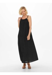 Robe maxi noire avec bretelles spaghetti réglables, encolure froncée et tissu texturé. Dispose d'un ajustement ample et d'une longueur jusqu'aux chevilles.