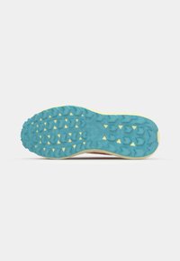 Multi-colored athletic shoe outsole featuring blue, yellow, and grey traction patterns; textured surface with various shapes for grip.