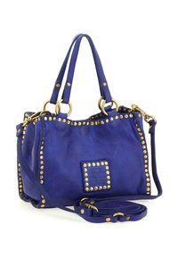 Borsa a mano in pelle blu con borchie dorate che delineano i bordi, due manici superiori e una tracolla removibile su uno sfondo bianco.
