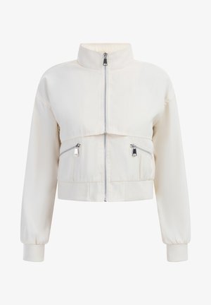 Lühendatud jakk heledast kreemjas kangast, kõrge krae, ees zipper sulgemine ja kaks tõmblukuga küljetaskut elastsete mansettidega.