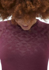 Maroon fitted athletic shirt with a geometric pattern, featuring a round neckline and subtle ribbed texture.