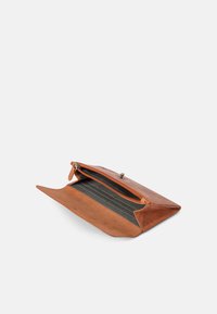 Brown leather clutch with a textured finish, zip closure, and striped fabric lining. Features an open design for easy access.