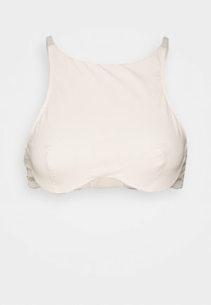 Beige ribbed crop top dengan tali lebar dan pita solid. Memiliki tekstur halus dan desain tanpa jahitan dengan detail jahitan yang halus.