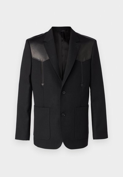 Black blazer featuring leather shoulder accents, notch lapels, two front pockets, and a single-button closure. Smooth, tailored design.