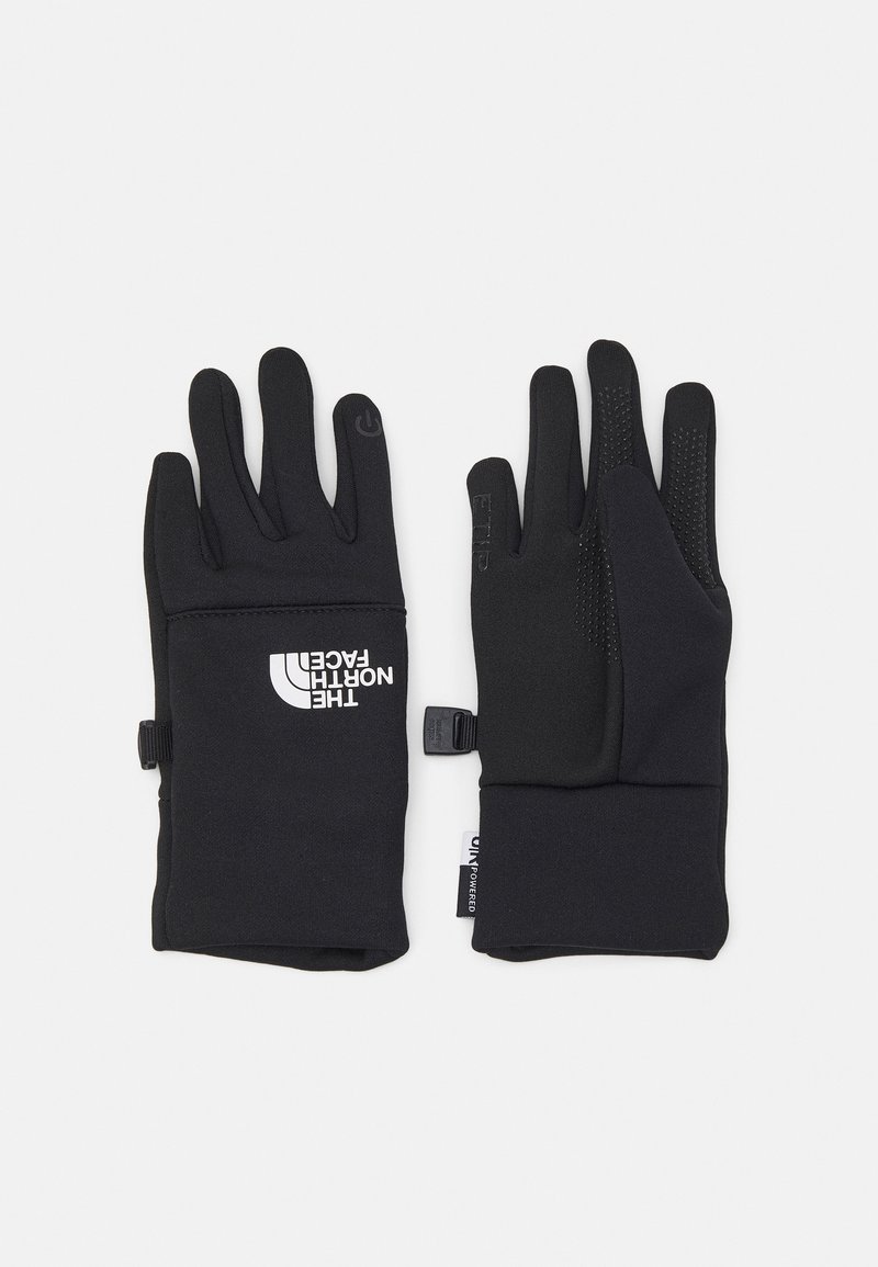 Sorte stretch-hansker med teksturerte fingertupper og en logo på baksiden. Har justerbare håndleddslukkinger og en myk, glatt overflate.