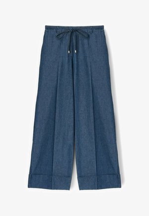 Szerokie niebieskie dżinsowe spodnie z ściągaczem w pasie i podwiniętymi nogawkami, ułożone płasko na białym tle.