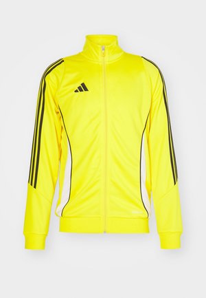 Gelbe Sportjacke mit schwarzen Streifen und Akzenten. Verfügt über einen hohen Kragen und einen Reißverschluss, besteht aus weichem Material.
