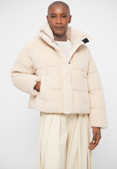 Light beige cropped puffer jacket with a soft, textured finish, oversized collar, two front pockets, and a button closure.
