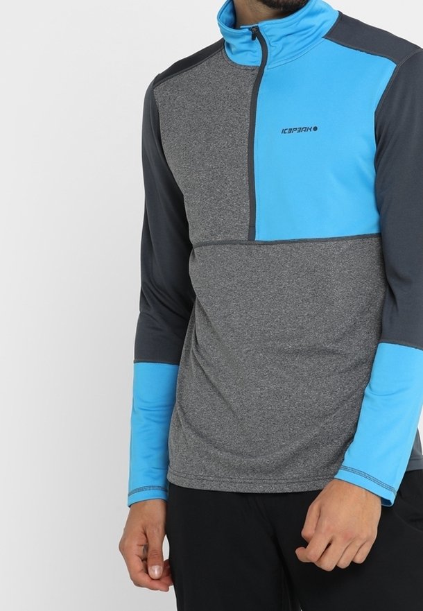 Sudadera gris de manga larga con cremallera, panel de acento azul y ribete negro. Presenta una media cremallera y puños azules contrastantes. Tejido texturizado.