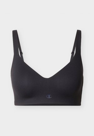 Melnas bezšuvju sporta krūšturis ar regulējamām lencēm un nelielu logo priekšpusē, paredzēts komfortam un vieglai atbalstīšanai.