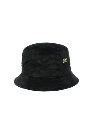 Chapeau seau en velours côtelé noir avec une surface texturée, présentant un logo de crocodile vert décoratif sur le côté et un large bord.