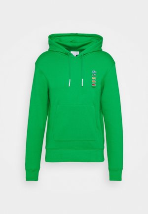 Hellgrüner Kapuzenpullover mit Fronttasche, Kordelzug und mehrfarbigen Krokodil-Logos mit dem Schriftzug "Polaroid" auf der Brust.