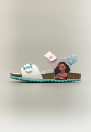 Sandale blanche et turquoise pour enfants avec un motif de personnage sur le côté, boucle réglable et brides auto-agrippantes, semelle en liège.