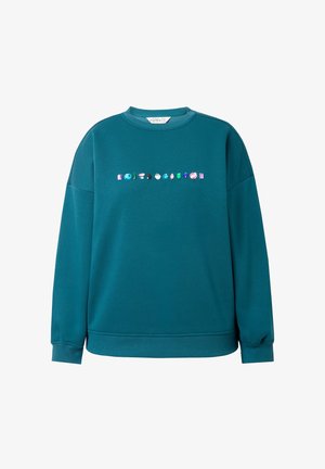 Sweatshirt surdimensionné teal en tissu doux, ornée d'une rangée d'appliqués colorés en forme de gemmes sur la poitrine, avec des poignets et un ourlet côtelés.
