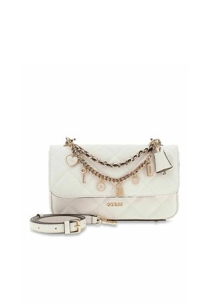 Sac à main matelassé blanc Guess avec chaîne dorée et décorations de charme, comprenant un cœur, une clé et une cloche, avec une bandoulière blanche détachable à côté.