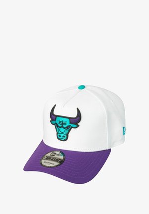 White cap with a purple visor, featuring an embroidered turquoise bull logo on the front. Adjustable size with a branded tag underneath.