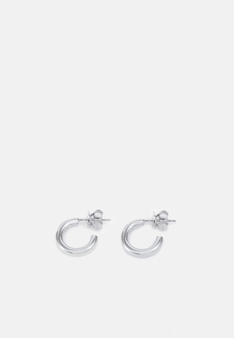 Silver hoop earrings with a polished finish, featuring a circular design and stud post for secure fastening. Rounded, smooth texture.