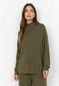 Olivově zelený dlouhý rukáv top s vysok�ým krkem. Měkká textura, volný střih, spadlá ramena a jemný melírovaný vzor.