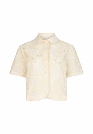 Blouse crème à manches courtes avec broderie florale texturée, boutonnage devant et ourlet arrondi.