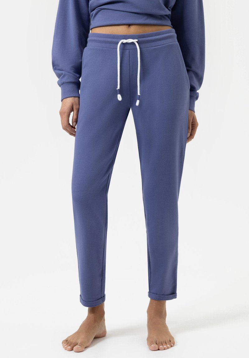 Paarse katoenen sweatpants met een trekkoord in de taille, slim fit en omgeslagen manchetten. Gladde textuur met contrasterende witte trekkoordaccenten.