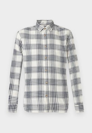 Camisa de manga larga a cuadros en crema y azul marino, hecha de tela texturizada, con cierre frontal de botones y diseño de cuello clásico.