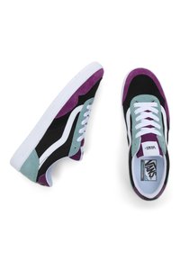 Un paio di sneakers Vans con suole bianche, pannelli neri e viola, dettagli in suede turchese, lacci bianchi e una striscia laterale bianca su uno sfondo bianco.
