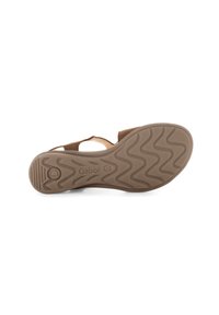 Suola di sandalo marrone con un motivo a zigzag. Presenta dettagli di branding e una forma arrotondata, realizzata in un materiale flessibile simile alla gomma.