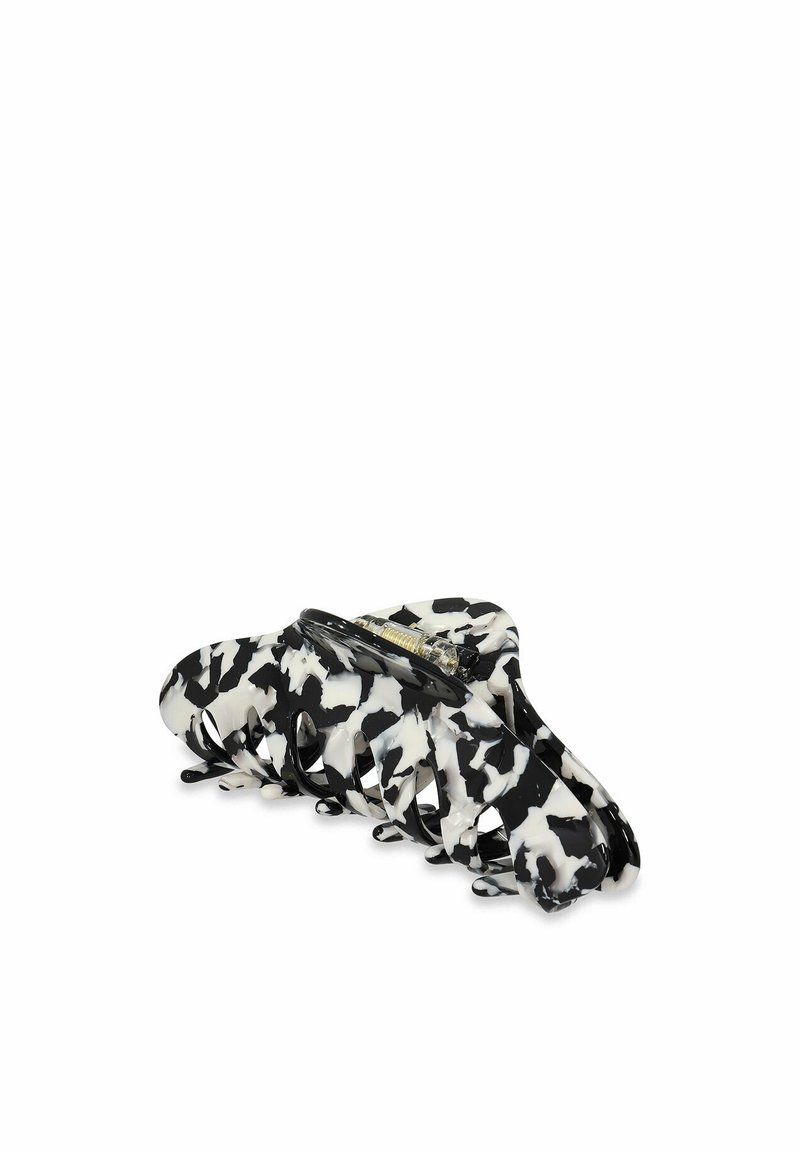 Clips per capelli in plastica bianco e nero con design a fantasia mucca, dotati di una cerniera resistente e di denti curvi per una presa sicura.