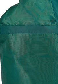 Green, smooth fabric with a glossy sheen, featuring a horizontal satin band stitched across the upper section. Lightweight and flexible texture.