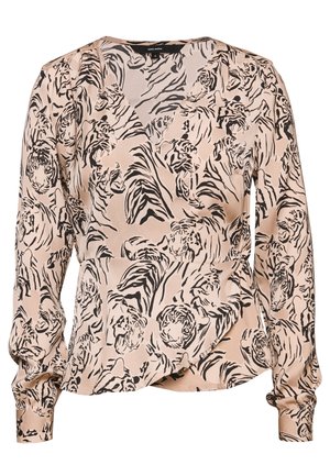 Blouse beige à manches longues avec motif de visage de tigre abstrait noir et rayures, poignets à boutons et col en V.
