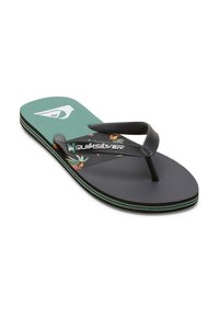 Mustat varvastossut, joissa on vihreä kukkakuosisuunnittelu pohjassa, tekstuuroitu pohja ja mustat hihnat. Quiksilver-logo hihnassa ja varvassangassa.