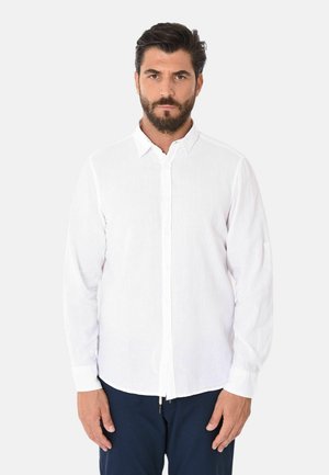 Camicia bianca a maniche lunghe realizzata in un tessuto leggero, con chiusura a bottoni e colletto a punta. Trama liscia con una vestibilità informale.