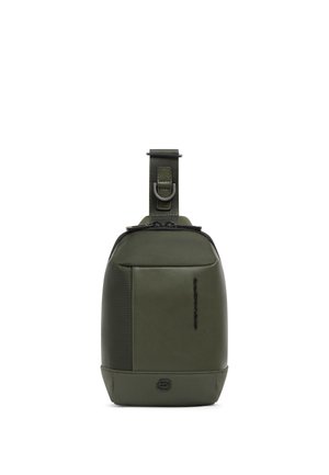 Compact olive green sling bag with front pocket, top zipper, adjustable strap, and black logo on plain white background.