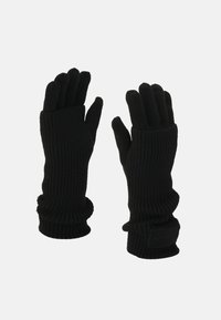 Guanti neri lavorati a maglia con texture a coste e polsini allungati per ulteriore calore. Presentano un tessuto liscio senza marchi visibili.