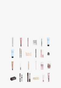 Variety of cosmetics including tubes, pencils, and compact. Features colors like pink, beige, silver, and green. Diverse shapes and designs.