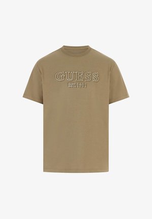 T-shirt kaki a maniche corte con logo ricamato "GUESS EST. 1981" in colore a contrasto. Realizzata in morbido cotone con scollo rotondo.
