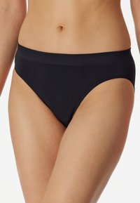 Black bikini briefs made of smooth fabric, featuring a moderate rise, thin elastic waistband, and a minimalist design without patterns.