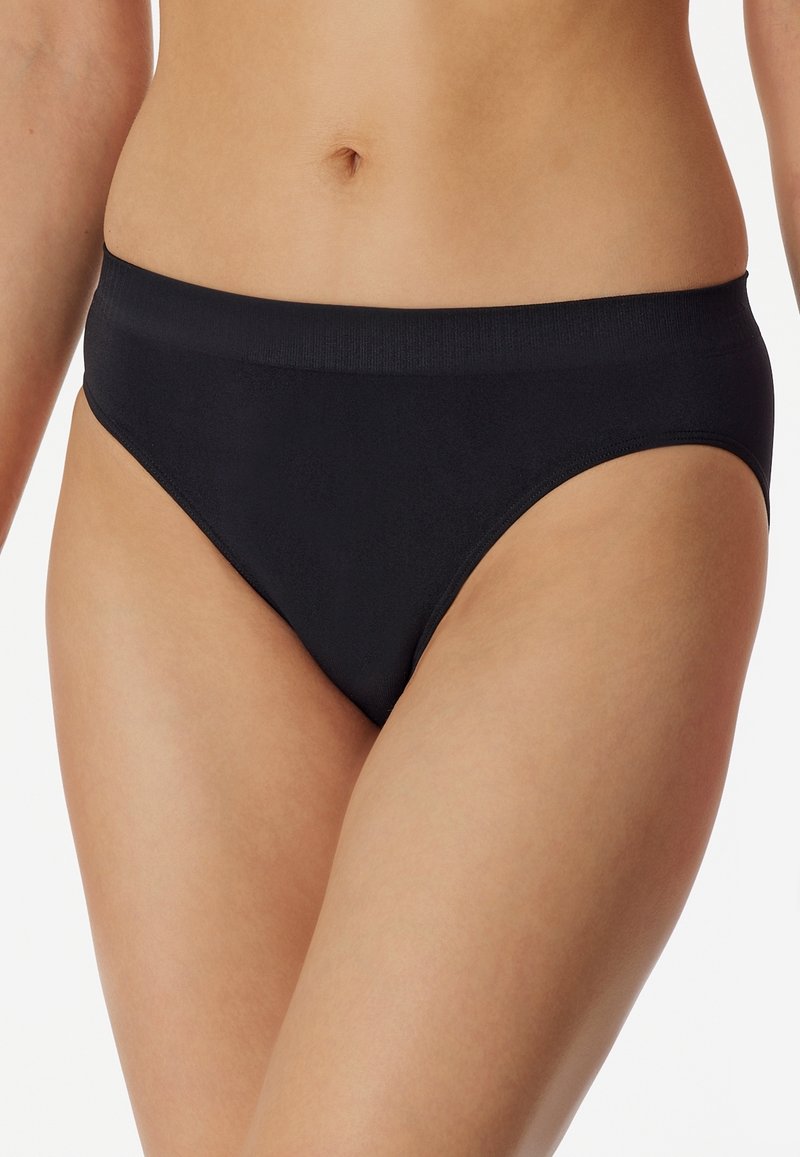 Black bikini briefs made of smooth fabric, featuring a moderate rise, thin elastic waistband, and a minimalist design without patterns.