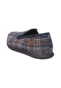 Pantofole di lana con un motivo a quadri navy, morbido al tatto, forma arrotondata, suola in gomma nera e dettaglio del logo in pelle beige sul lato.