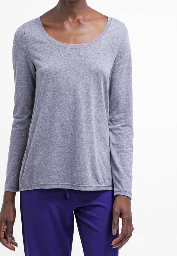 Långärmad topp med rundad halsringning i ljusgrått tyg med en mjuk textur; har en liten logga på bröstet och en avslappnad passform.