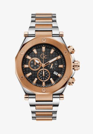 Kronograafkellaga, millel on must tekstuuriga dial, roosa kuldne detail ja hõbedane roostevaba terasest käevõru. Sisaldab kuupäeva kuva ja alamdialooge.