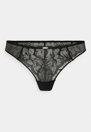 Black lace thong with floral pattern, sheer mesh front, solid black back, and a slim waistband featuring a small gold accent.