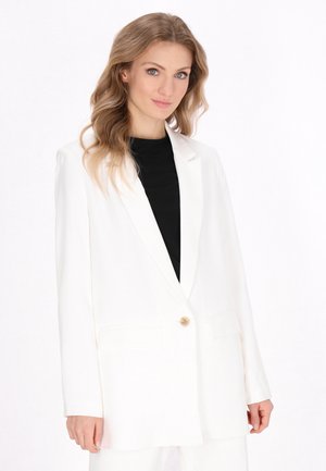 White blazer with a tailored design, single button closure, two front pockets, and a smooth texture. Worn over a black top.