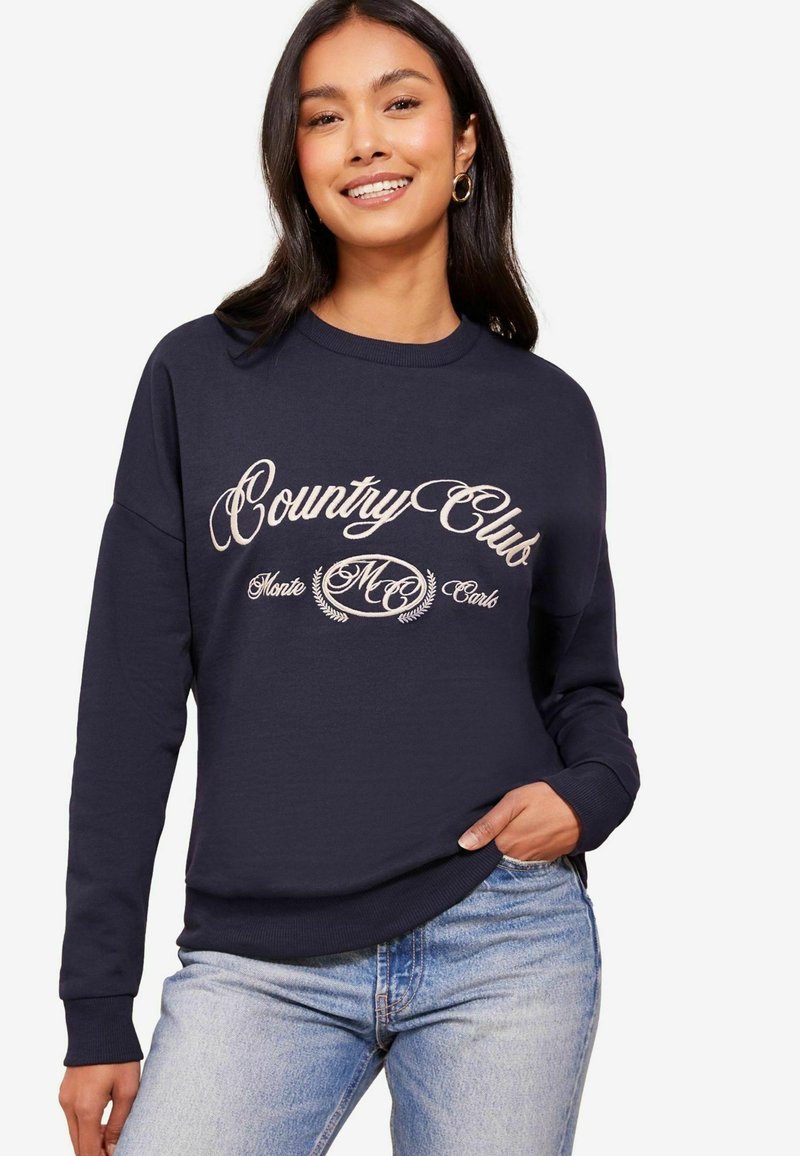 Sudadera azul marino con "Country Club Monte Carlo" en una elegante escritura crema, con puños y dobladillo acanalados, fabricada en una tela suave y cómoda.